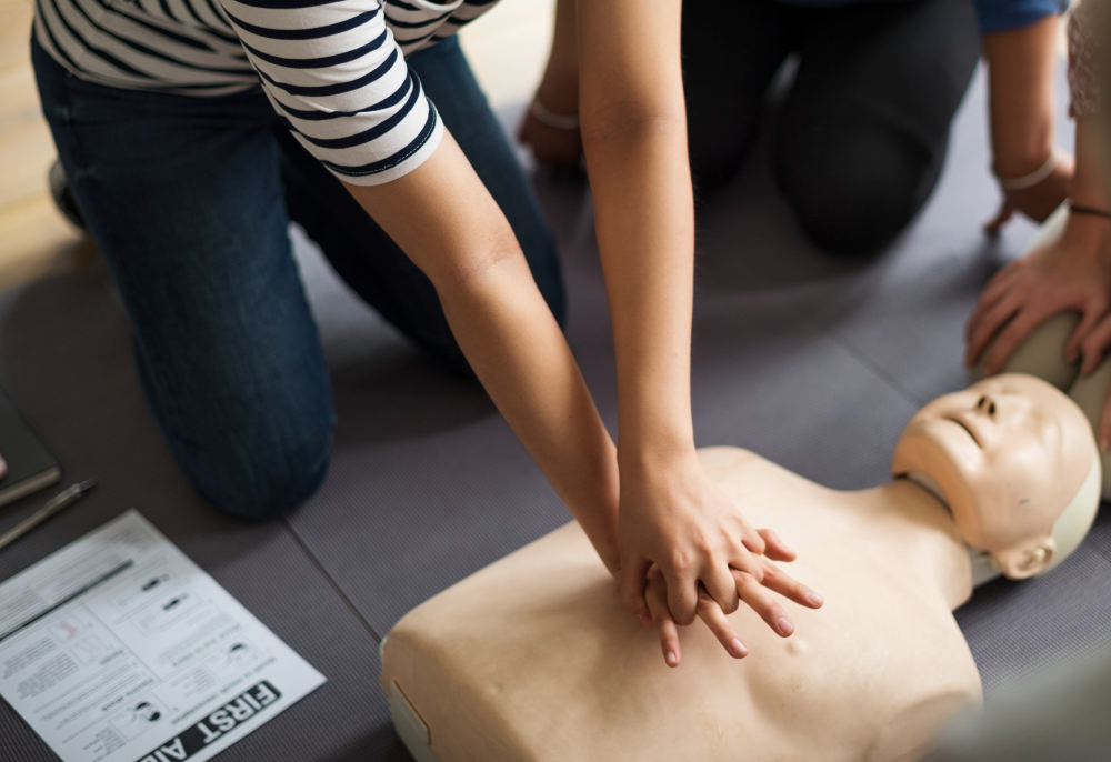Adult CPR demonstration showing chest compressions, rescue breathing, and AED use