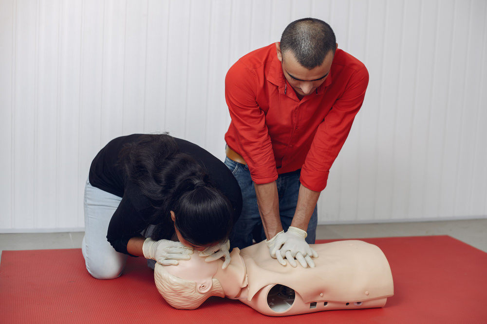 Adult CPR demonstration with chest compressions, rescue breaths, and AED use