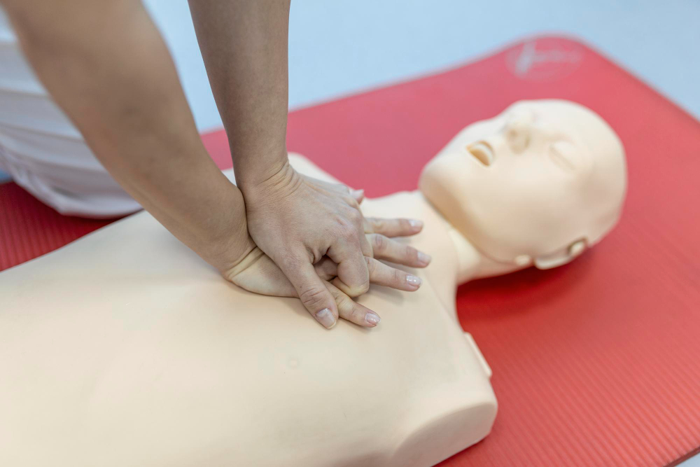 Instructor demonstrating child and infant CPR with safe compression techniques and airway management